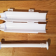 disassembled sushi bazooka in four parts, including what look like two cups and a rod